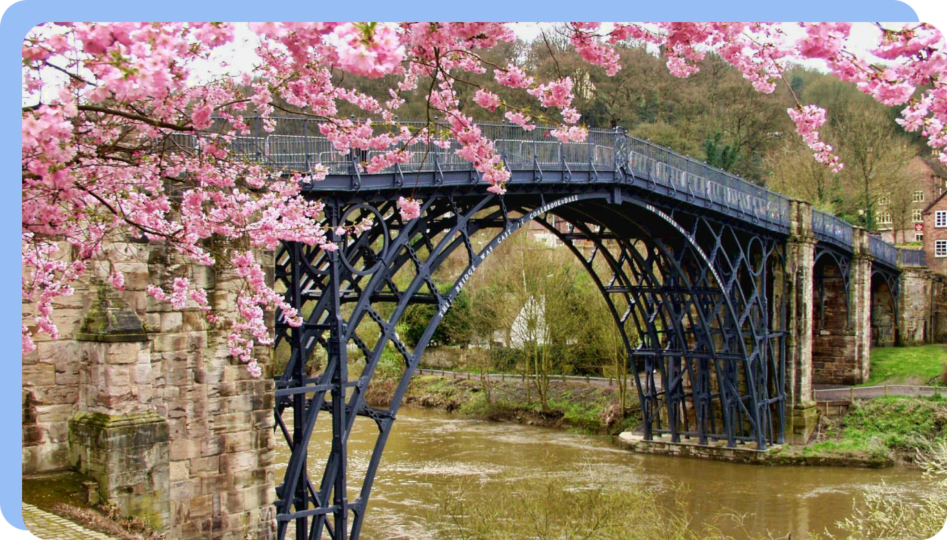 Iron bridge framed by cherry blossoms